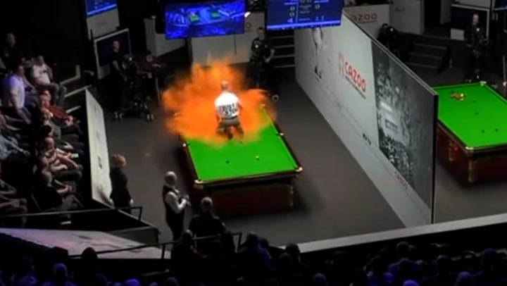 Protester covers snooker table in orange powder during World Championships