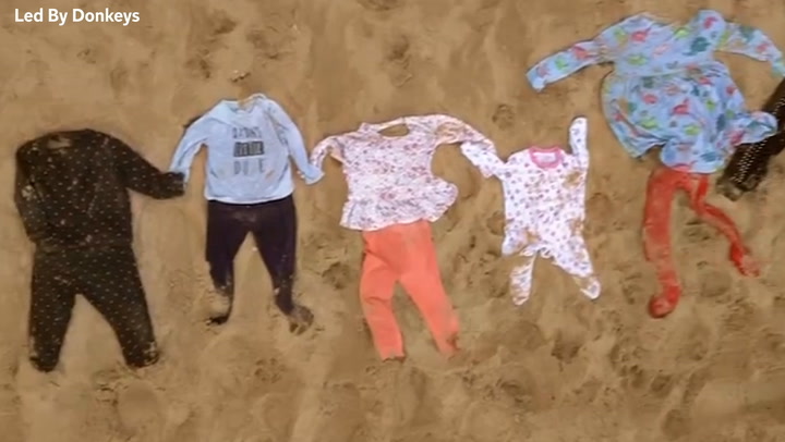 Children’s clothing stretching 5km laid out on beach in Gaza war protest