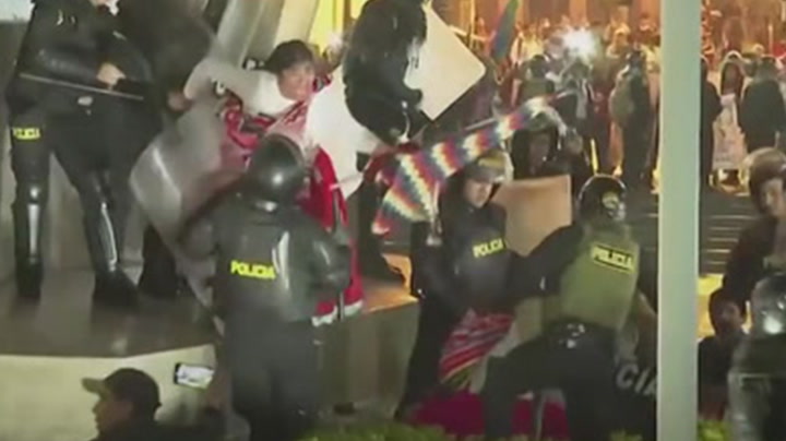 Clashes erupt between riot police and demonstrators at government protest in Peru