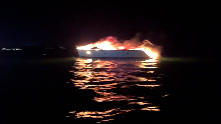 Boat engulfed by flames before sinking off coast of Florida