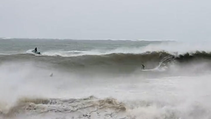 New Zealand surfers ride large waves during Cyclone Gabrielle