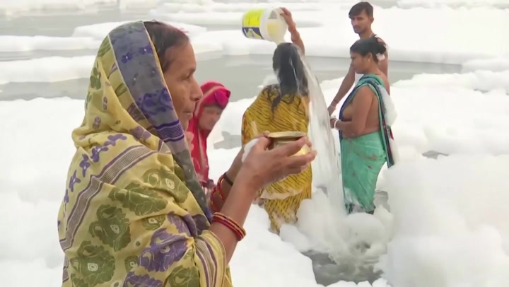 Women bathe in sacred Indian river covered in toxic foam | News |  Independent TV