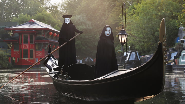 Creepy masked figures paddle down London canal at 5am