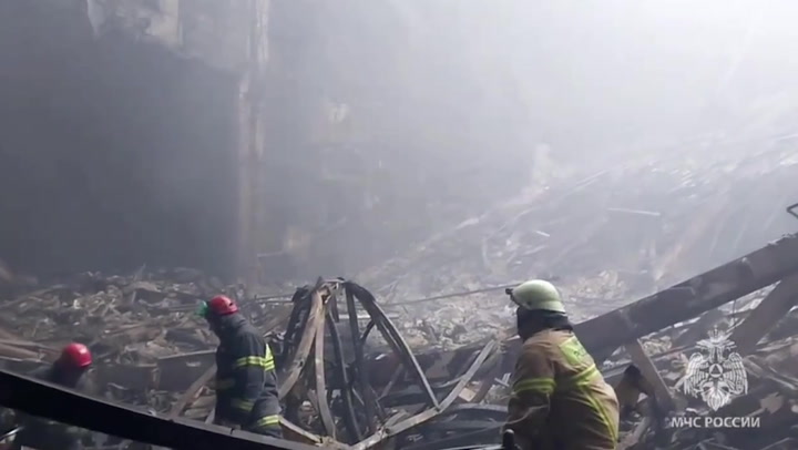 Emergency services wade through rubble at site of Moscow attack
