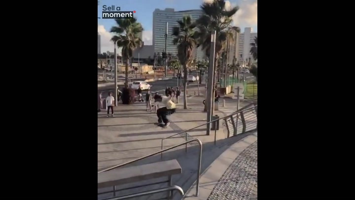 Skater's ollie over a flight of stairs ends in near-miss