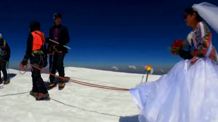 Bride and groom climb freezing 21,000ft snowcapped mountain to get married
