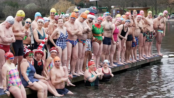 Hardy swimmers jump into lake in London’s Hyde Park for traditional Christmas swim