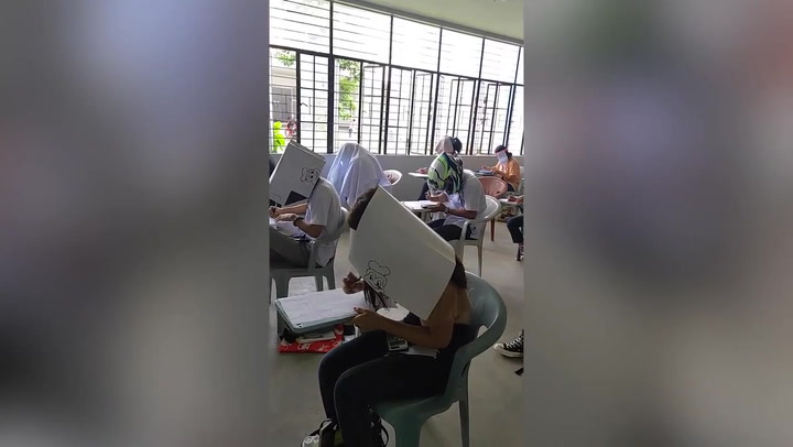 Students in Philippines wear bizarre 'anti-cheating' hats to block peripheral vision