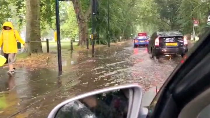 Heavy rains flood roads around London's Clapham Common