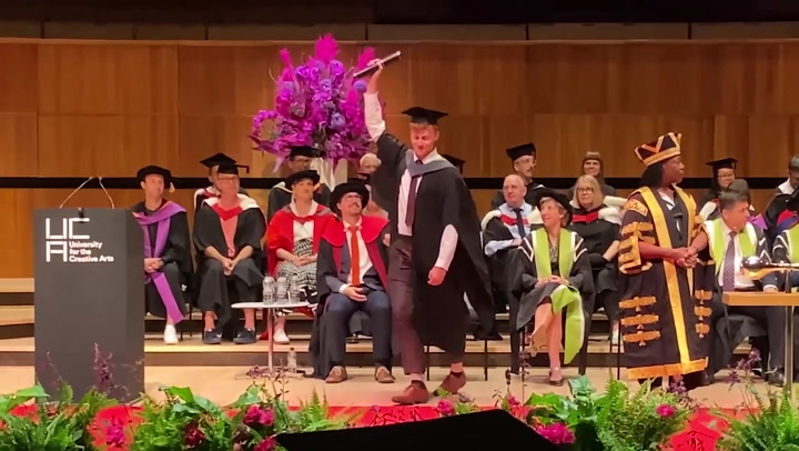 Graduate takes Banksy's honorary degree after artist fails to show up at ceremony