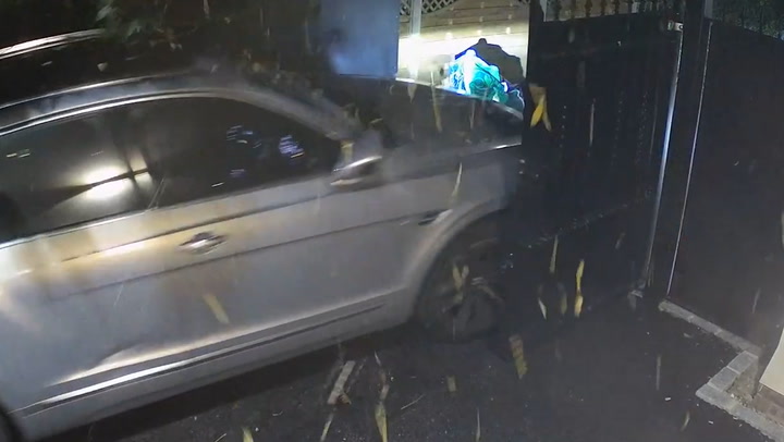 Moment gang of luxury car thieves ram keyless vehicle through gate after 'hacking' it
