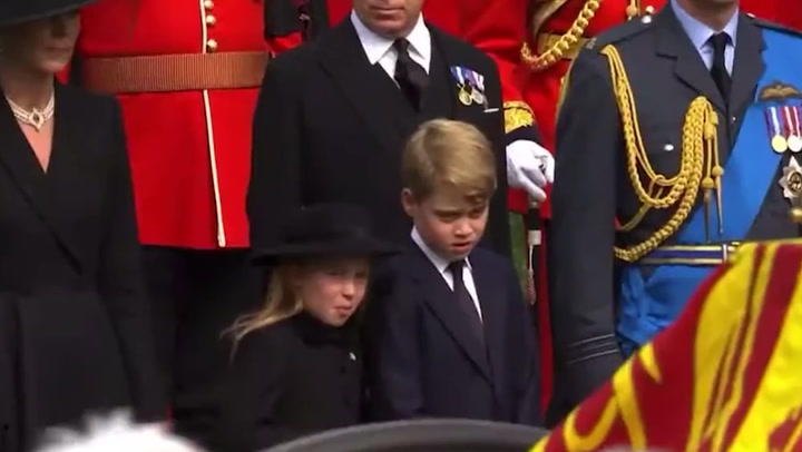 Prince George and Princess Charlotte chat during the Queen's funeral procession