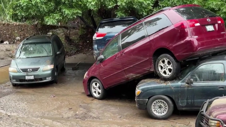 Abandoned cars piled up in street after heavy flooding in San Diego