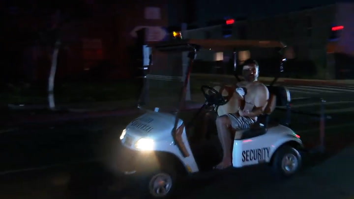 Shirtless man driving stolen golf cart with dog on his lap chased by police