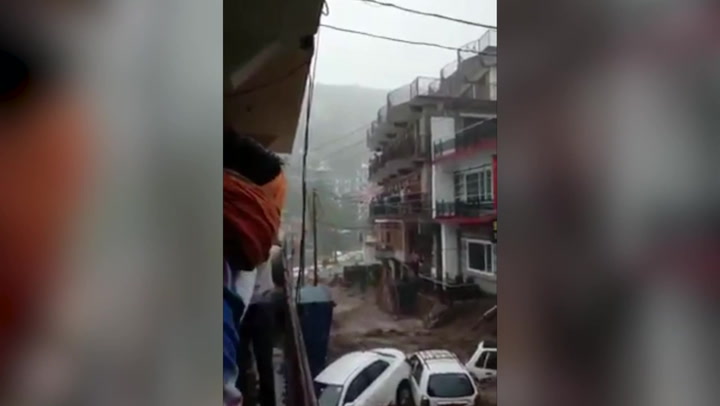 River of mud pours down street in India after cloudburst triggers flash flood