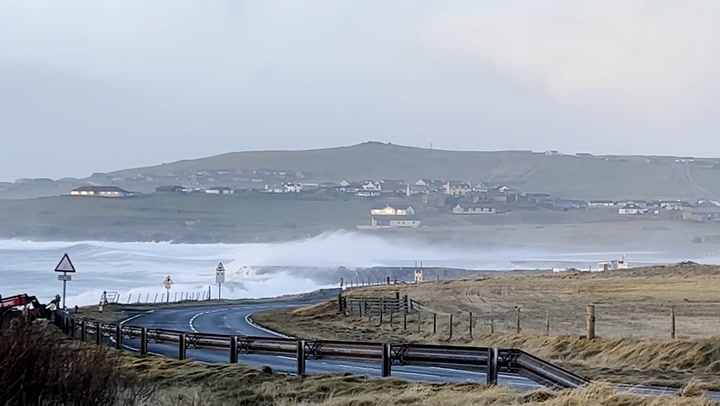 Waves crash over runway at Shetland's Sumburgh airport as 85mph winds batter UK