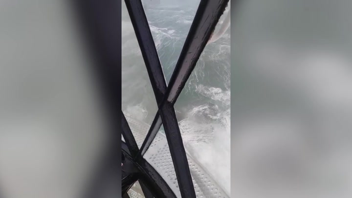 Lighthouse battered by huge waves as Storm Barra creates treacherous conditions