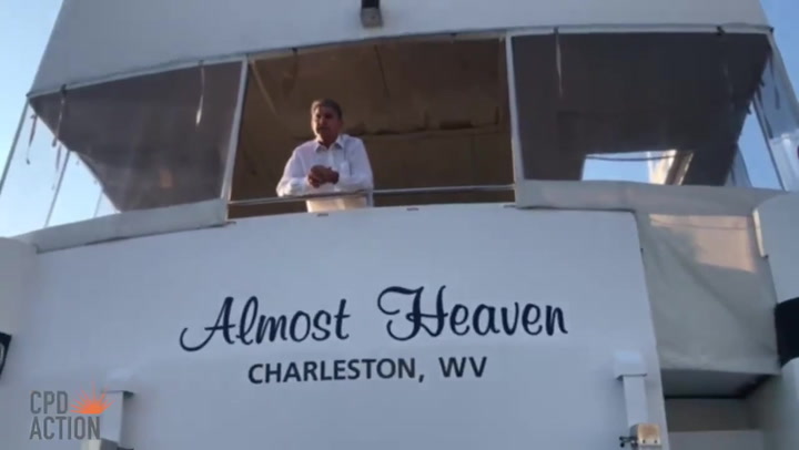 Joe Manchin leans over deck of his yacht to tell protesters why he'll  oppose funding healthcare expansion | The Independent