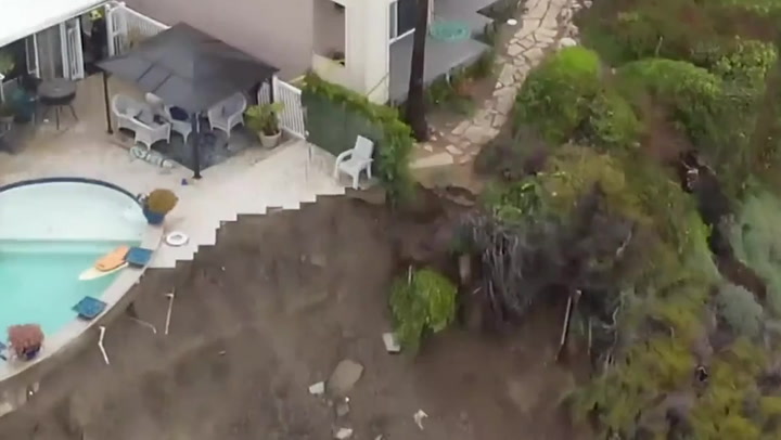 Swimming pool hangs over edge of crumbling cliff after landslide in California