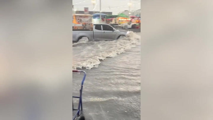 Heavy rain turns road into a canal in southern Thailand