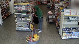 Shoplifter crams rucksack with bottles of wine in CCTV footage