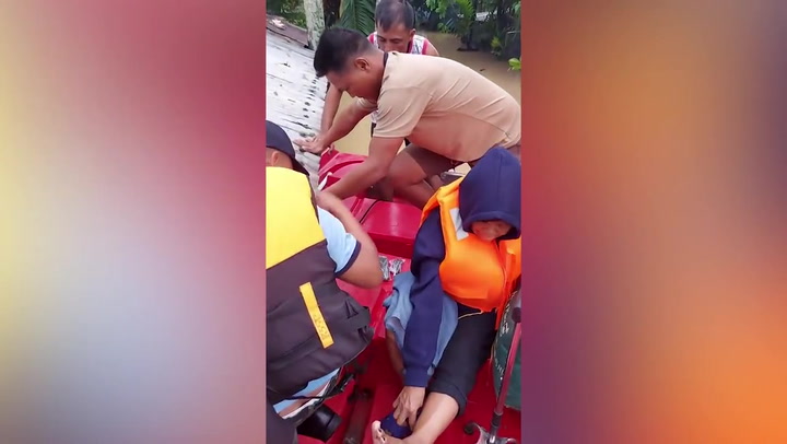 Rescue teams evacuate residents on rubber rafts as Typhoon Doksuri floods village in the Philippines