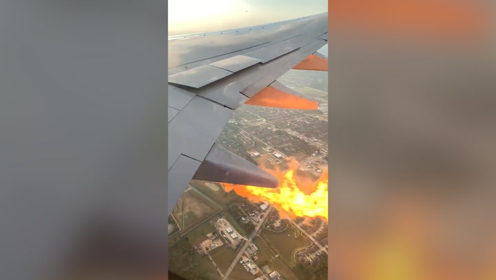 Passenger films flames shooting out of wing of Southwest Airlines plane midflight