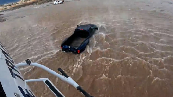 Motorist rescued from submerged car after ignoring flood warnings in Arizona