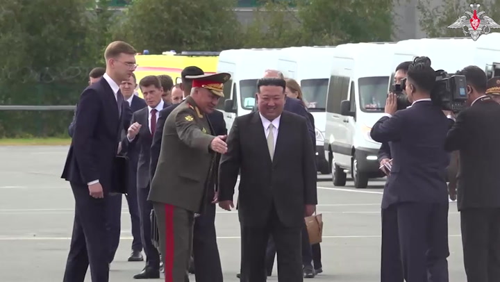 Kim Jong-un shakes hands with Russian defence minister on visit to military site
