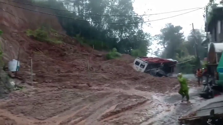 Locals run for cover when mudslide crashes down hillside in the Philippines