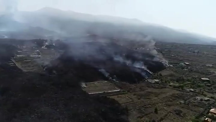 Aerial footage shows charred land surrounding La Palma volcano