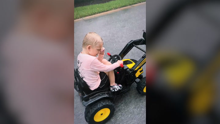 Lara Trump's five-year-old son drives his toy car outside during Hurricane Ian
