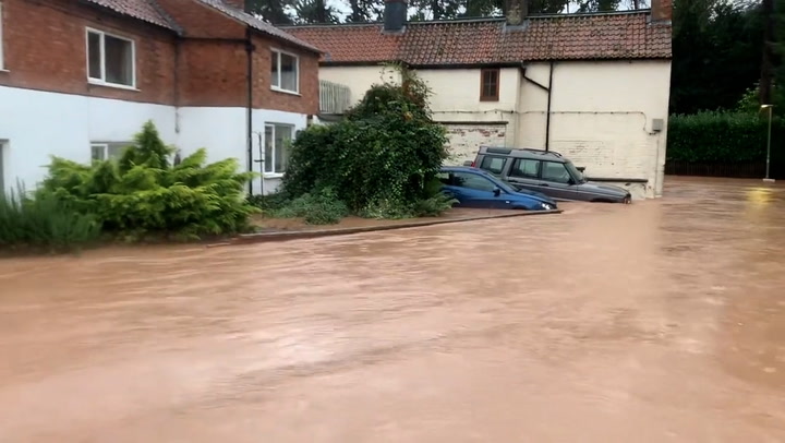 Pubs and houses flooded as deep floodwater rushes down road in Nottinghamshire village