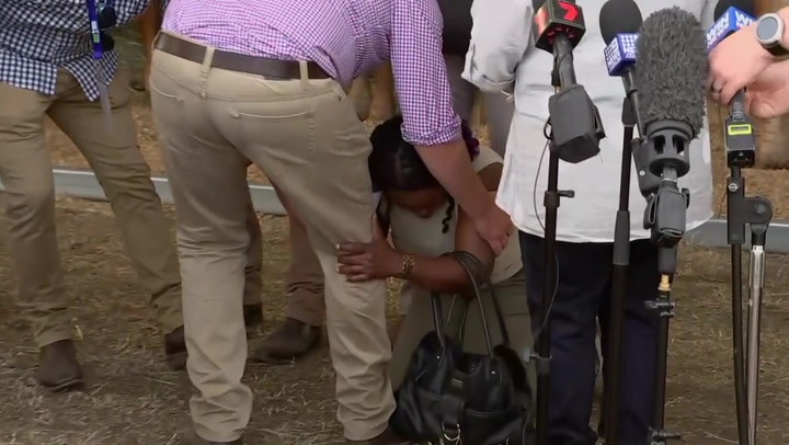 Woman from Cameroon drops to knees pleading for help from Australian PM Scott Morrison