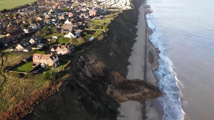 Homes left dangling on edge of cliff after landslide in Norfolk
