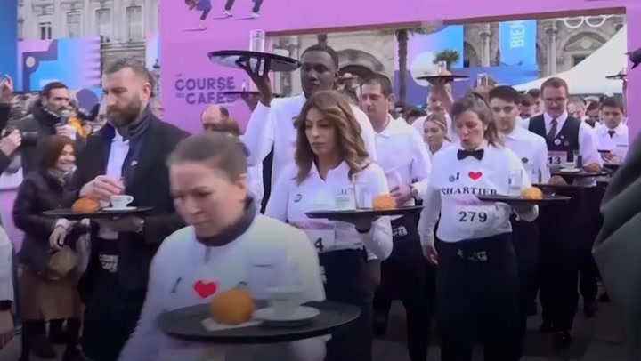 Paris waiters don traditional aprons and shirts to battle it out in revived croissant race