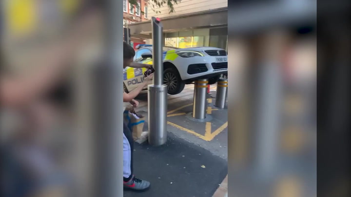 Police car lifted onto two wheels after officers park over automatic bollards