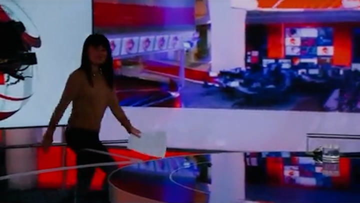 BBC newsreader races studio camera back to seat to stay in shot