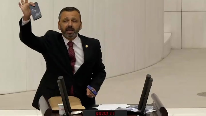 Turkish MP smashes phone with hammer in parliament