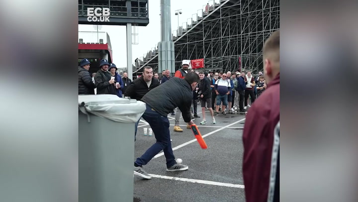England fans play cricket outside Old Trafford as rain delays final day of Test