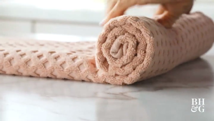 How to roll a towel for packing (step-by-step).