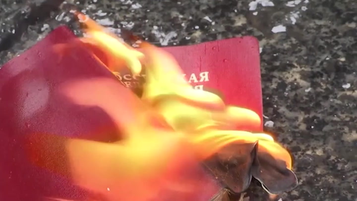 Anti-war protestor burns his Russian passport at Belgrade march against war on Ukraine