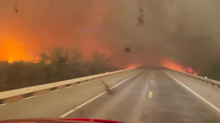 Fire engine drives through raging inferno as wildfire spreads in Texas