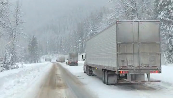 Stalled trucks along snowy I-90 in Montana