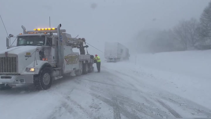 Truck hauled out of snow as extreme cold hits New York