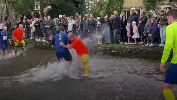 Traditional river football match excites crowds in Cotswold village