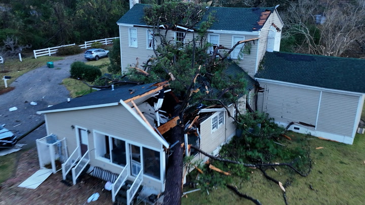 Tornado rips roof off apartment building, shoves trees onto homes