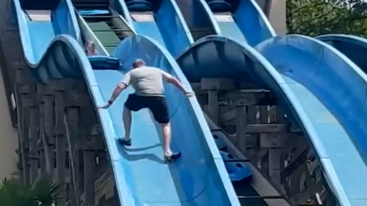 Dad scales theme park water slide to rescue stuck daughter