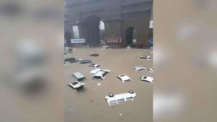Cars float down roads as heavy flooding hits central China