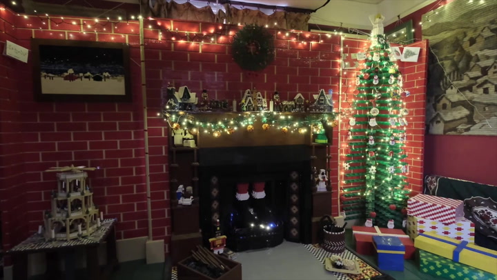 Lego-loving couple build 12ft Lego Christmas wall complete with fireplace